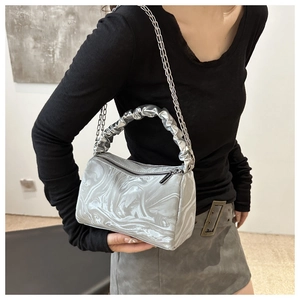 Detail of silver marble print pleated handbag with metal chain and glossy texture