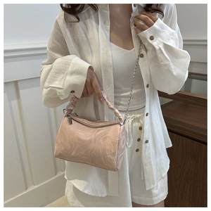 Detail showing marble pattern pink pleated handbag with silver chain and dual zippers