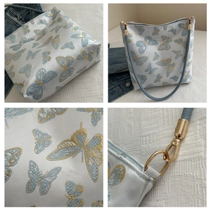 Detail shots of lace butterfly bucket bag showing embroidery fabric and gold hardware