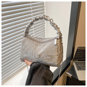 Detail of silver marble texture handbag with ruched handle and metal chain strap