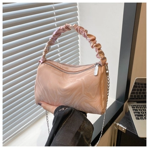 Close-up of pink marble print handbag with pleated handle and silver chain strap details