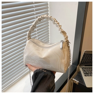 Detail of white marble pattern small square bag with ruched cloud handle and silver chain