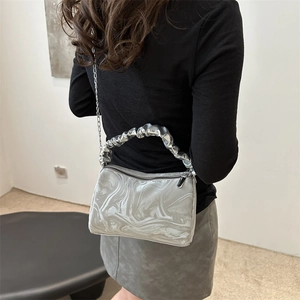Fashionable silver marble pleated handbag with chain strap shown on model shoulder