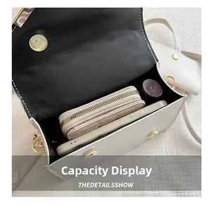 Interior view showing capacity for a smartphone, wallet, and lipstick in a white flap bag