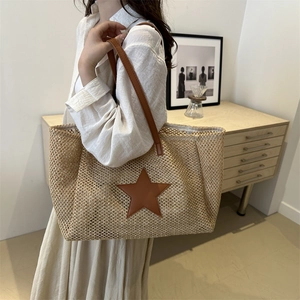 Straw woven tote bag with dark brown leather star patch and long slim shoulder straps