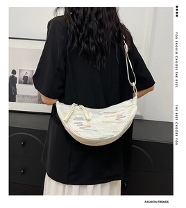 Detailed back view of a white crescent crossbody bag with colorful geometric stripes