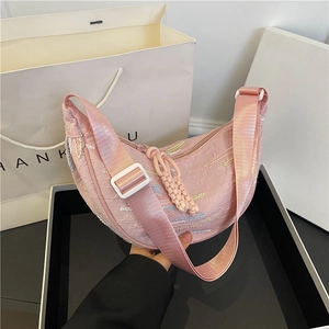 Pink pleated crescent shoulder bag with rainbow embroidery and woven rope charm