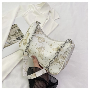 White crescent underarm bag with gold butterfly and celestial prints featuring silver chain