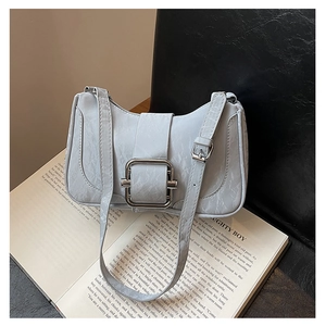 Detail of light grey underarm bag with cracked texture leather and silver square buckle