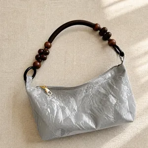 Detailed shot of DuPont paper tote bag with polished wooden beads and rope handle