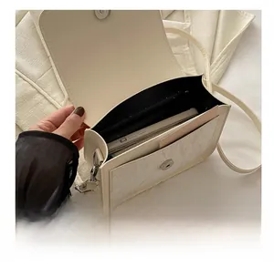 Interior view of cream butterfly crossbody bag showing spacious main compartment space