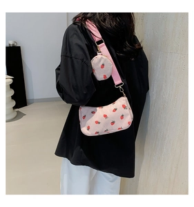Detail of pink corduroy shoulder bag with strawberry print and small matching coin purse