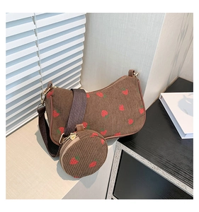 Detail of strawberry print brown corduroy crescent bag with small round coin purse