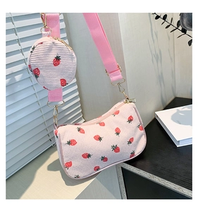 Detail of pink corduroy shoulder bag with strawberry print and small round coin purse