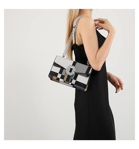 Detail of multi-color geometric crossbody bag with iconic crystal square buckle and silver chain