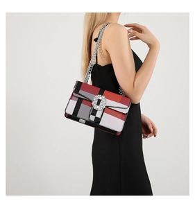 Detail of a chic plaid shoulder bag with a sparkling rhinestone buckle and silver chain