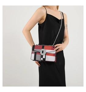 Detail of a chic plaid crossbody bag with a sparkling rhinestone buckle and silver chain