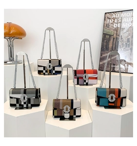 Detailed display of striped crossbody bags with crystal buckles and chain straps