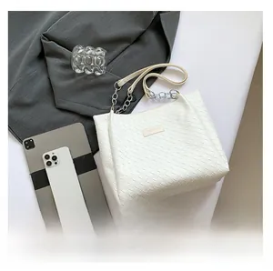 Detailed top view of white woven tote bag showing large capacity and chain shoulder strap
