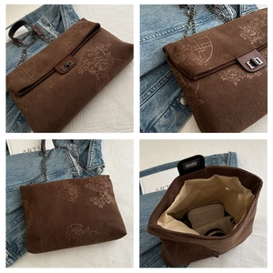 Detail view of vintage dark brown corduroy bag with floral print and metal lock