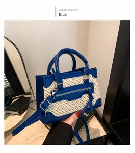 Detail of blue faux leather and beige woven fabric stitching on a stylish handbag