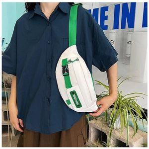 Detail of white fashion chest bag with green adjustable strap and WOAINI text patch