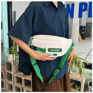 Outdoor shot of white nylon chest bag with green straps and adjustable buckle detail