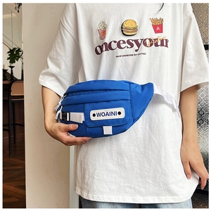 Detail of blue nylon waist bag featuring a white adjustable strap and front logo patch