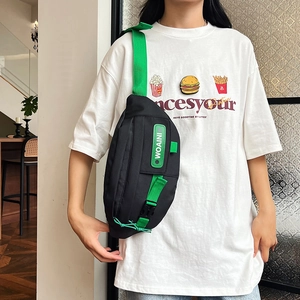 Black nylon chest bag with neon green strap and WOAINI tag for streetwear fashion
