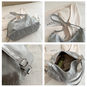 Detailed views of silver metallic tote bag showing texture, hardware, and large capacity