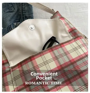 Detail view of pink checkered tote bag featuring a front pocket and magnetic silver buckle