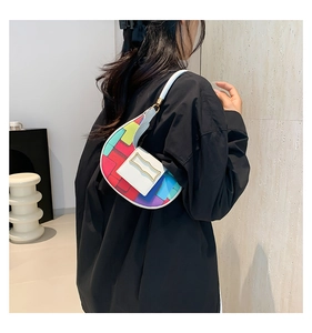 Close-up of a colorful geometric patchwork underarm bag with a gold metal buckle