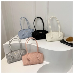 Stack of pleated leather shoulder bags in blue, black, white, silver, and pink
