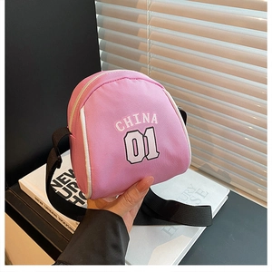 Close-up of pink canvas crossbody bag with white China 01 logo and adjustable black strap