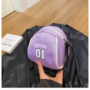 Detailed macro view of a purple basketball-shaped mini crossbody bag with a metal zipper
