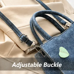 Detail of adjustable strap with silver buckle on blue denim texture crossbody bag