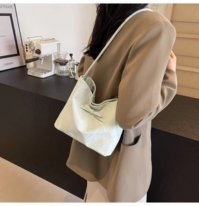 Sac fourre-tout vert menthe clair avec nœud porté à l'épaule dans un cadre de café
