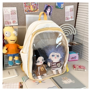 Detail view of yellow and white ita-bag with transparent PVC window for doll display