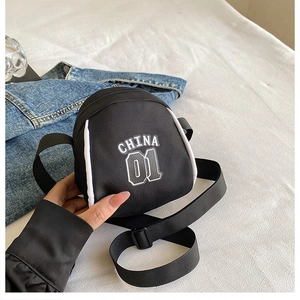 Detail of small black nylon crossbody bag with white China 01 lettering and sporty design