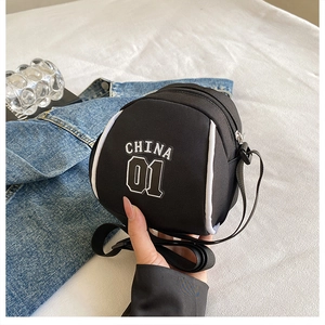 Detail of black sporty crossbody bag with white China 01 lettering and adjustable strap