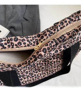 Close-up of high-quality golden metal zipper and leopard print tote bag interior