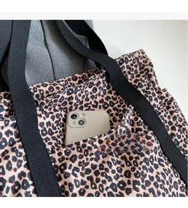 Detail of the leopard print canvas tote bag featuring a durable interior slip pocket