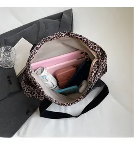 Detailed view of the leopard print tote bag interior showing large capacity and items