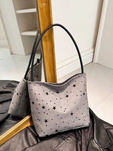 Grey canvas tote bag with black star print and leather shoulder strap for commute
