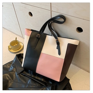Detailed shot of multi-color patchwork leather tote bag with elegant gold metal buckles