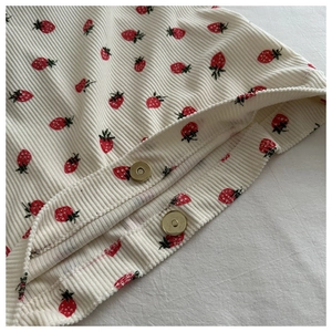 Gros plan sur tissu en velours côtelé fraise avec deux fermoirs aimantés dorés