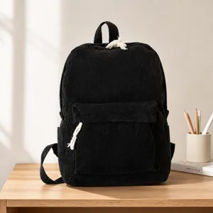 Detail of black corduroy backpack showing clear fabric texture and knotted zipper puller