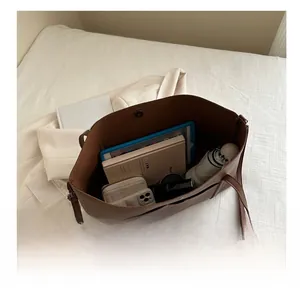 Top view of a large brown leather tote bag showing ample space for daily essentials