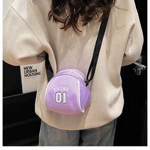 Close-up of purple canvas shell bag with China 01 print and adjustable black shoulder strap
