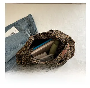 Spacious leopard print tote bag interior showing capacity for notebooks and essentials
